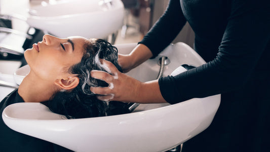 women getting her hair washed using herbal shampoo 