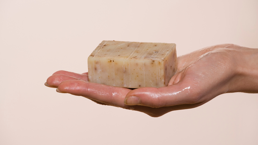 Bathing using handmade natural soap crafted with nourishing components like coconut oil and shea butter. 